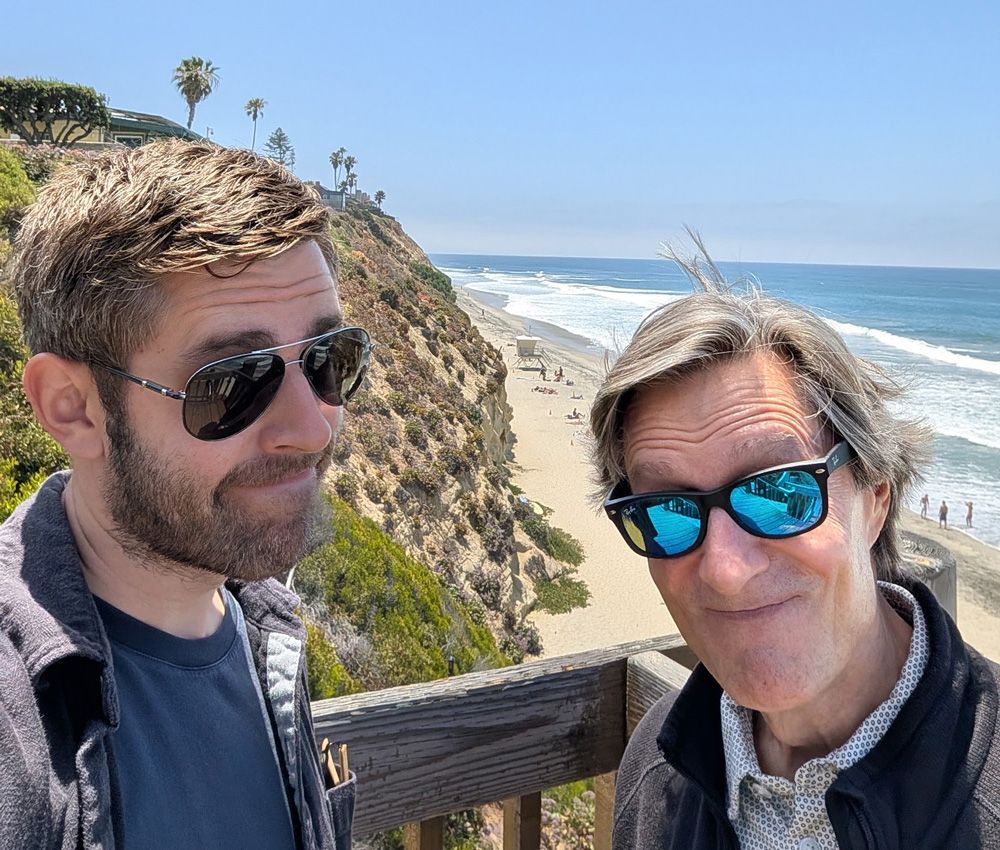 David and John Fox in sunglasses at the D Street overlook in Encinitas, with the beach and ocean behind them